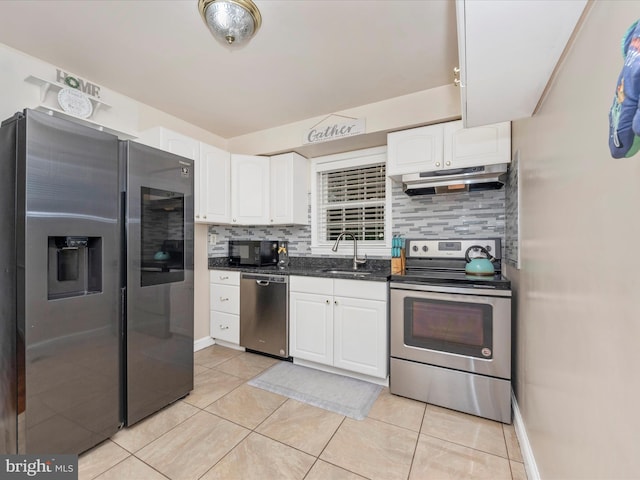 kitchen featuring decorative backsplash, stainless steel appliances, white cabinetry, and light tile patterned floors