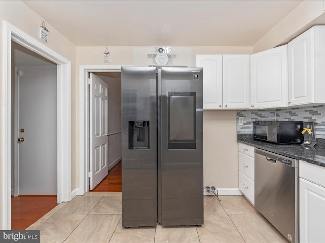 kitchen with appliances with stainless steel finishes, dark stone counters, decorative backsplash, and white cabinets