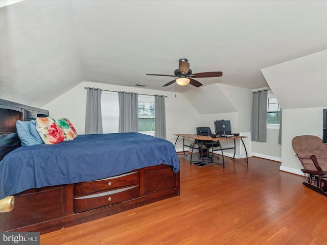 bedroom featuring multiple windows, vaulted ceiling, hardwood / wood-style floors, and ceiling fan