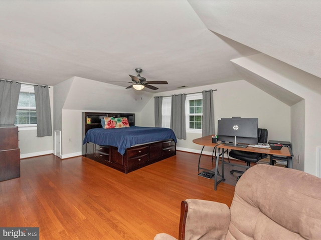 bedroom featuring multiple windows, wood-type flooring, lofted ceiling, and ceiling fan