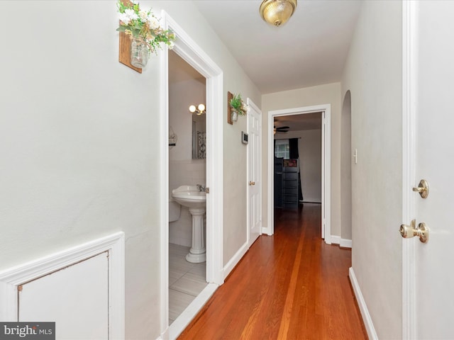 hallway with hardwood / wood-style floors