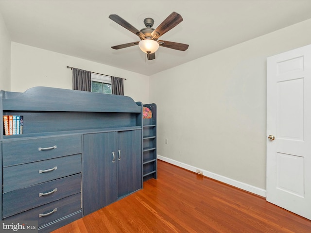 unfurnished bedroom with dark hardwood / wood-style flooring and ceiling fan