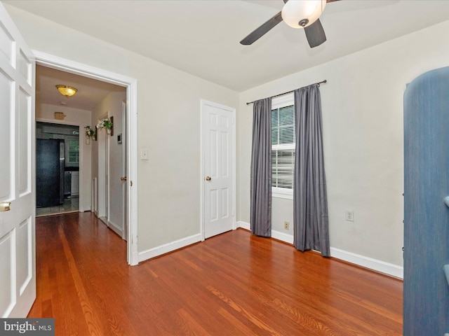 spare room featuring wood-type flooring and ceiling fan