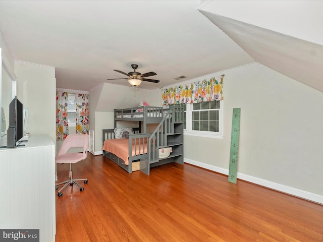 unfurnished bedroom featuring lofted ceiling and hardwood / wood-style floors