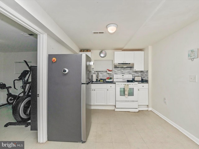 kitchen with white cabinets, stainless steel refrigerator, backsplash, and white range with electric stovetop