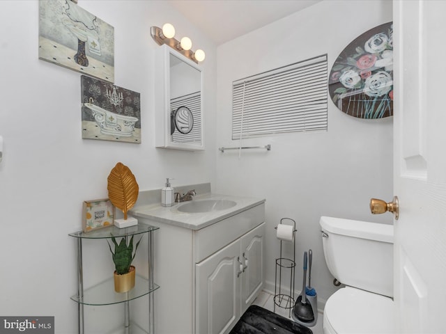 bathroom featuring vanity and toilet