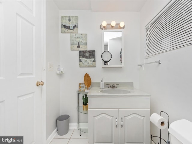 bathroom with vanity, toilet, and tile patterned floors