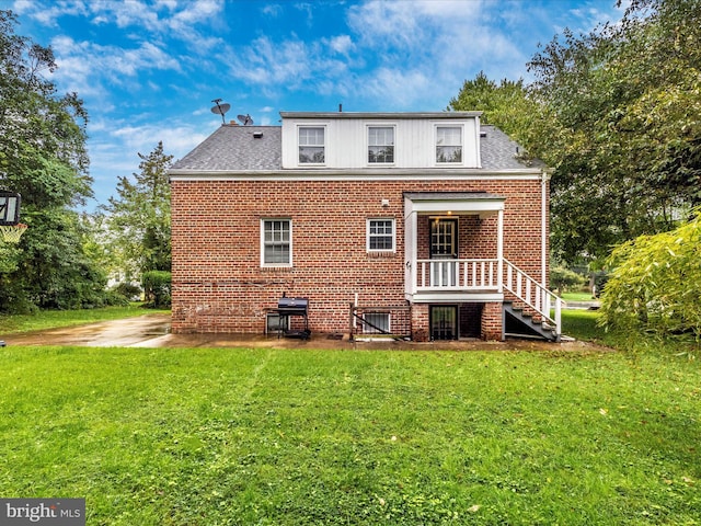 rear view of property with a yard