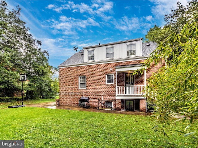 rear view of property with a lawn