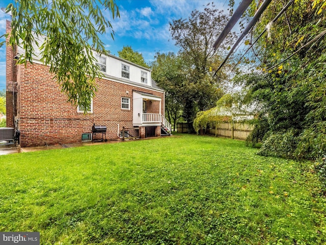 rear view of property with a lawn