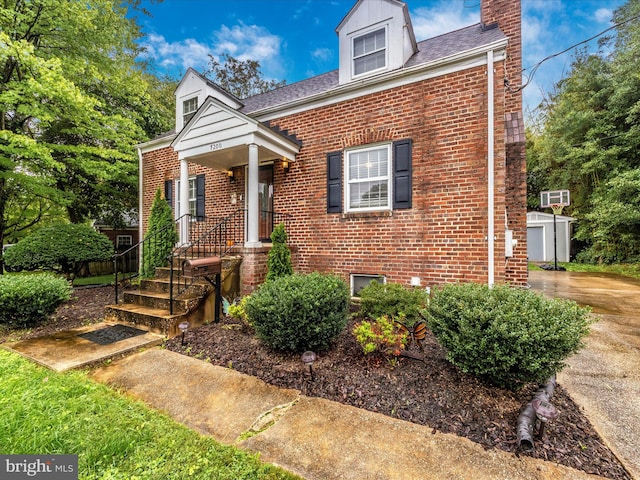 view of front of house featuring a storage shed