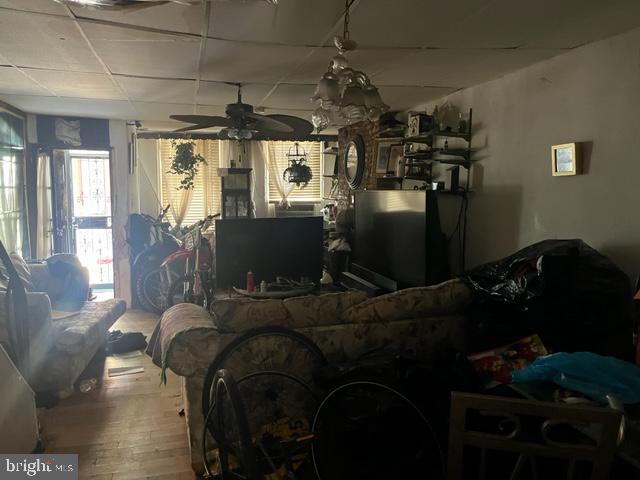 living room with ceiling fan and hardwood / wood-style floors