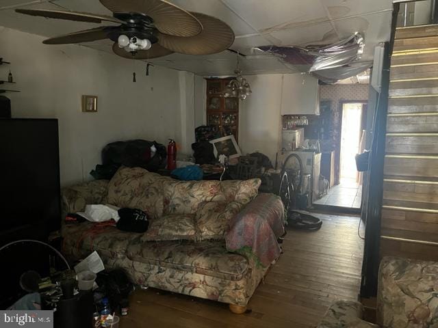 living room featuring wood-type flooring and ceiling fan