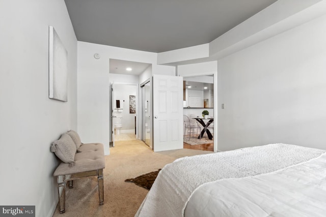 carpeted bedroom with ensuite bathroom