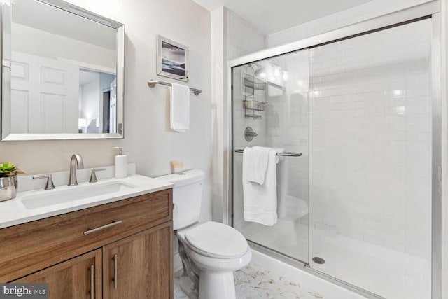 bathroom with walk in shower, vanity, and toilet