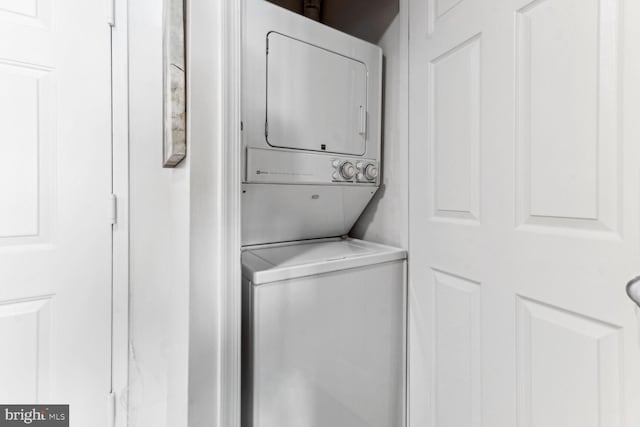 washroom with stacked washer / drying machine