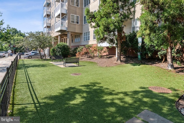 view of home's community featuring a lawn