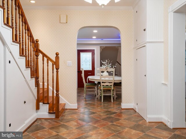 foyer entrance featuring crown molding