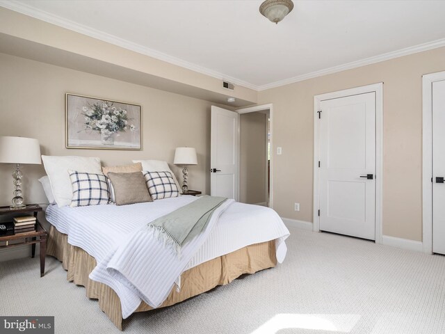 carpeted bedroom with ornamental molding