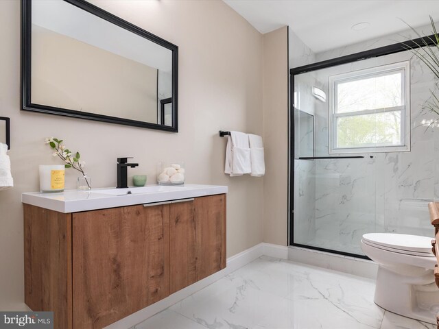 bathroom featuring vanity, toilet, and a shower with door