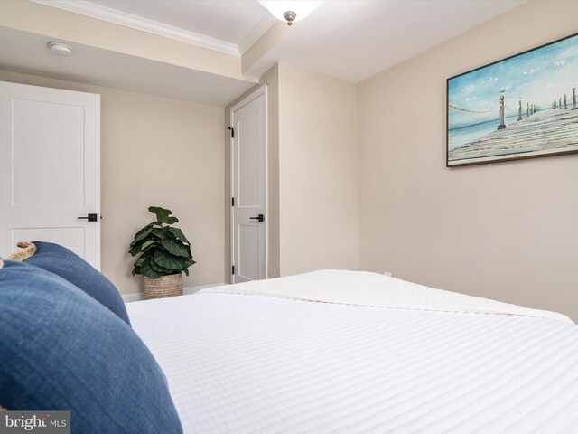 bedroom with ornamental molding