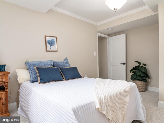 bedroom with ornamental molding and carpet floors