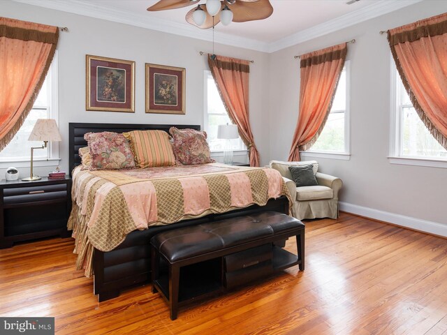 bedroom with crown molding, light hardwood / wood-style flooring, and ceiling fan