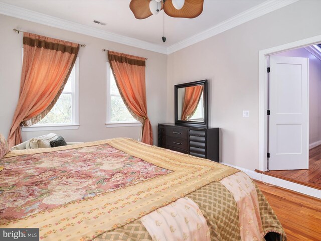 bedroom with ceiling fan, ornamental molding, and hardwood / wood-style floors