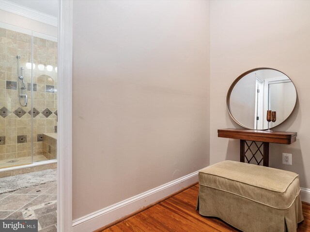 living area with hardwood / wood-style floors and crown molding