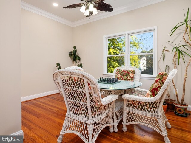 dining room featuring breakfast area, ceiling fan, hardwood / wood-style flooring, and crown molding