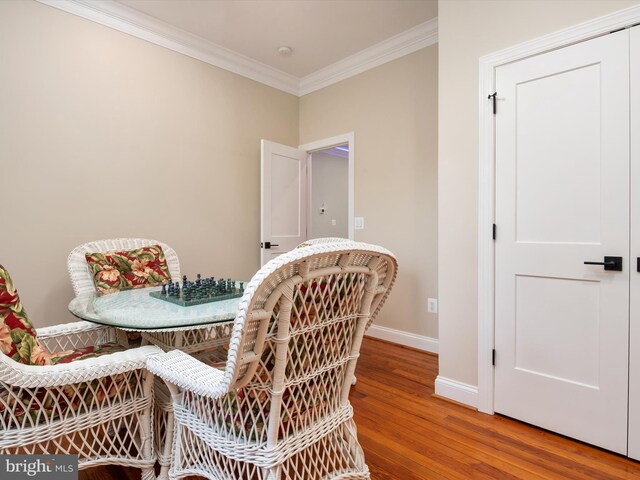 interior space with crown molding, hardwood / wood-style floors, and breakfast area