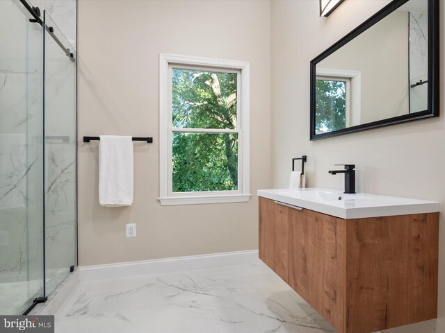 bathroom with vanity, a wealth of natural light, and walk in shower