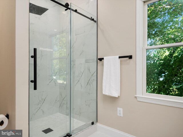 bathroom with a healthy amount of sunlight and a shower with shower door