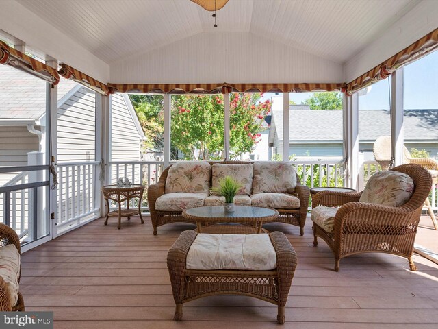 sunroom / solarium with vaulted ceiling and a healthy amount of sunlight