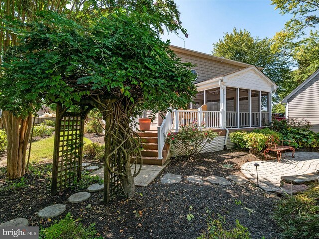 back of property with a patio and a sunroom