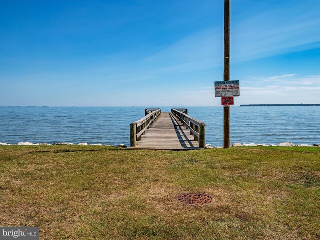 dock area featuring a water view and a yard