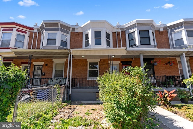 townhome / multi-family property featuring a porch