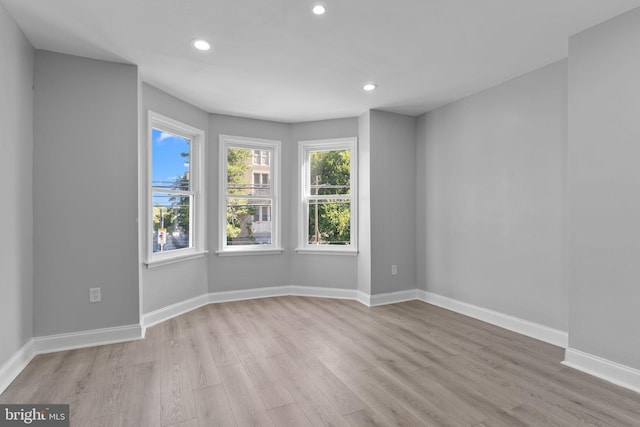 spare room with light hardwood / wood-style floors