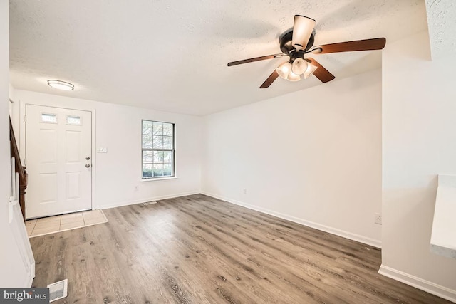 entrance foyer featuring hardwood / wood-style floors, ceiling fan, and a textured ceiling