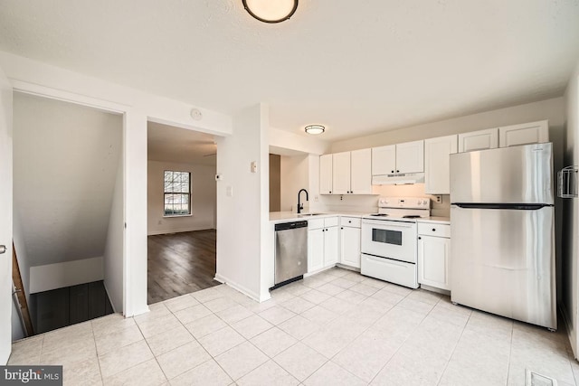 kitchen with light hardwood / wood-style flooring, stainless steel appliances, white cabinetry, and sink