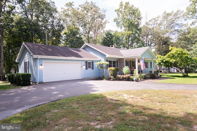 ranch-style home with a garage and a front lawn