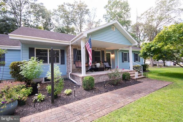 view of front facade featuring a front lawn, an outdoor living space, and a porch