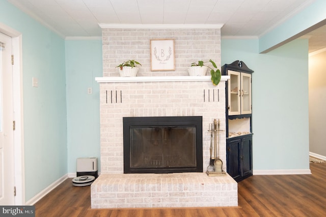 interior details with hardwood / wood-style floors, crown molding, and a brick fireplace