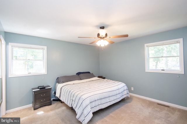 carpeted bedroom with ceiling fan