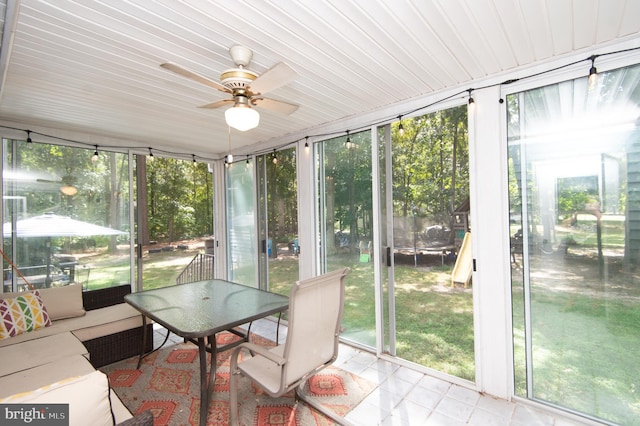 sunroom with plenty of natural light and ceiling fan