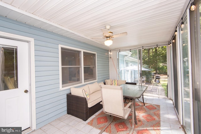 sunroom featuring ceiling fan