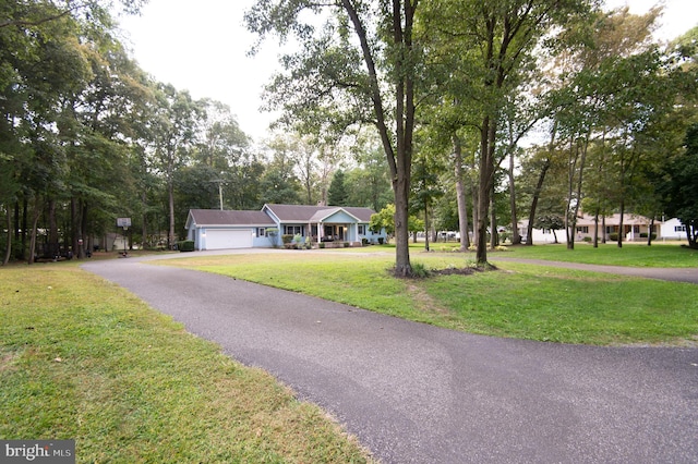 single story home with a front lawn and a garage