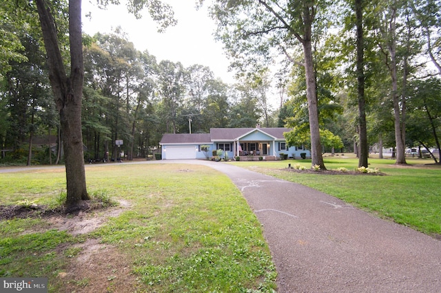 ranch-style house featuring a garage and a front lawn