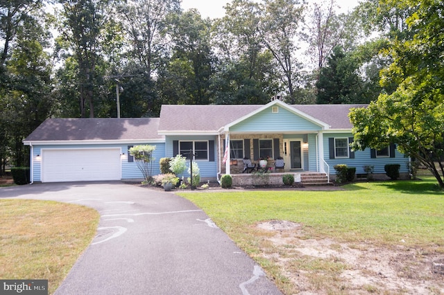 single story home featuring covered porch, a garage, and a front lawn