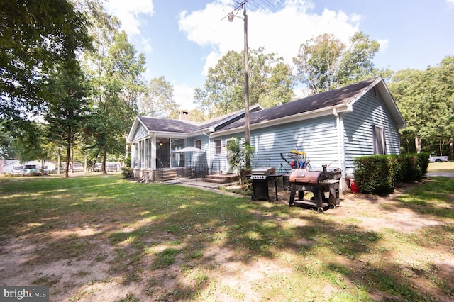 back of property featuring a lawn